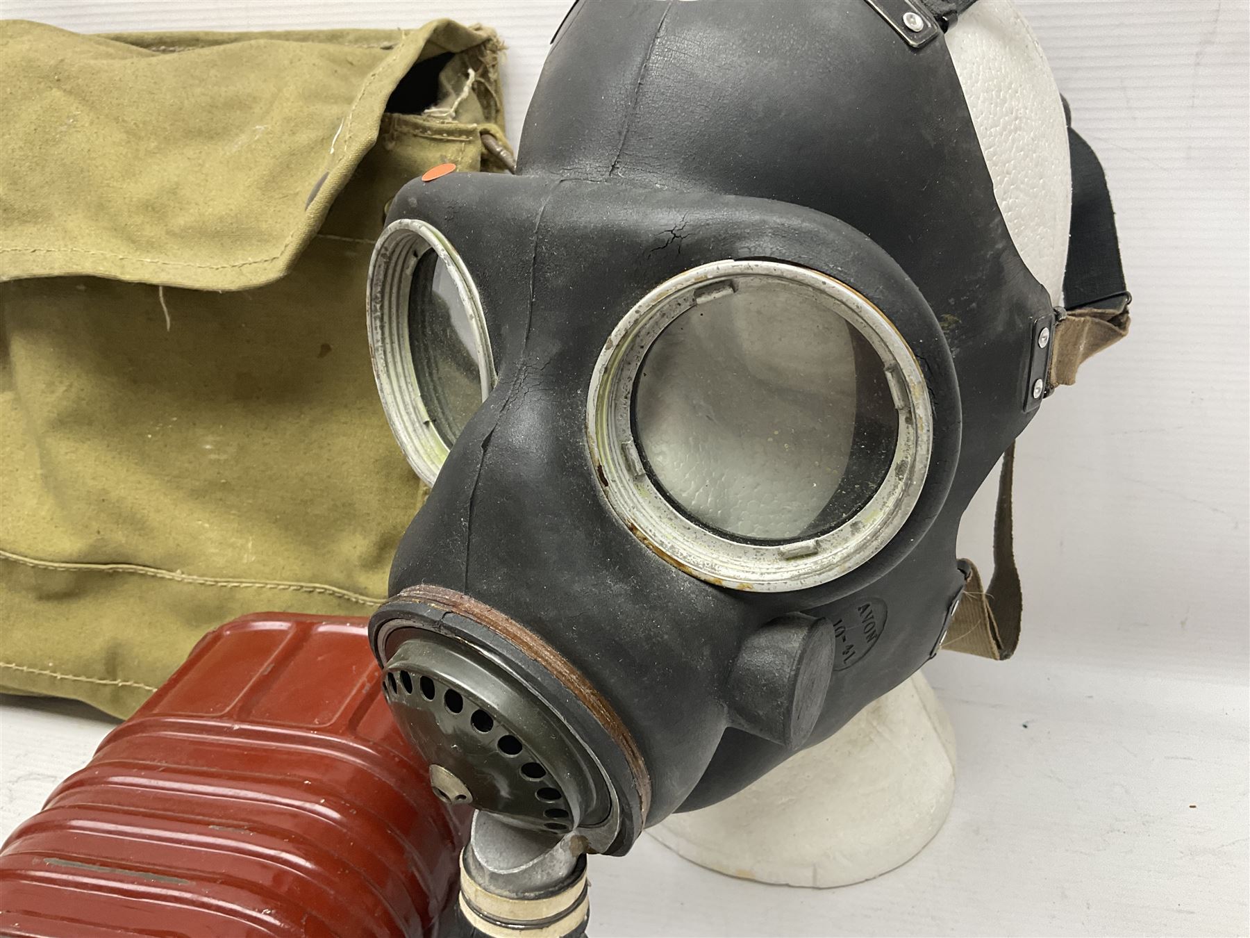 1970s British turtle style steel helmet with liner, green cover and netting; liner marked C.W.L. 1972 No.8415-99-973-6750; size 6 3/4 - 6 7/8; WWII respirator dated 1941 in canvas carrying case; and a Native long-shafted spear with iron head and bound plain round haft L165cm (3)