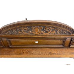 Oak overmantle mirror, arched pediment carved with shield and flanking fish with trailing scrollwork, panelled frieze over extending canopy raised by turned and fluted column pilasters, bevelled mirror plate 