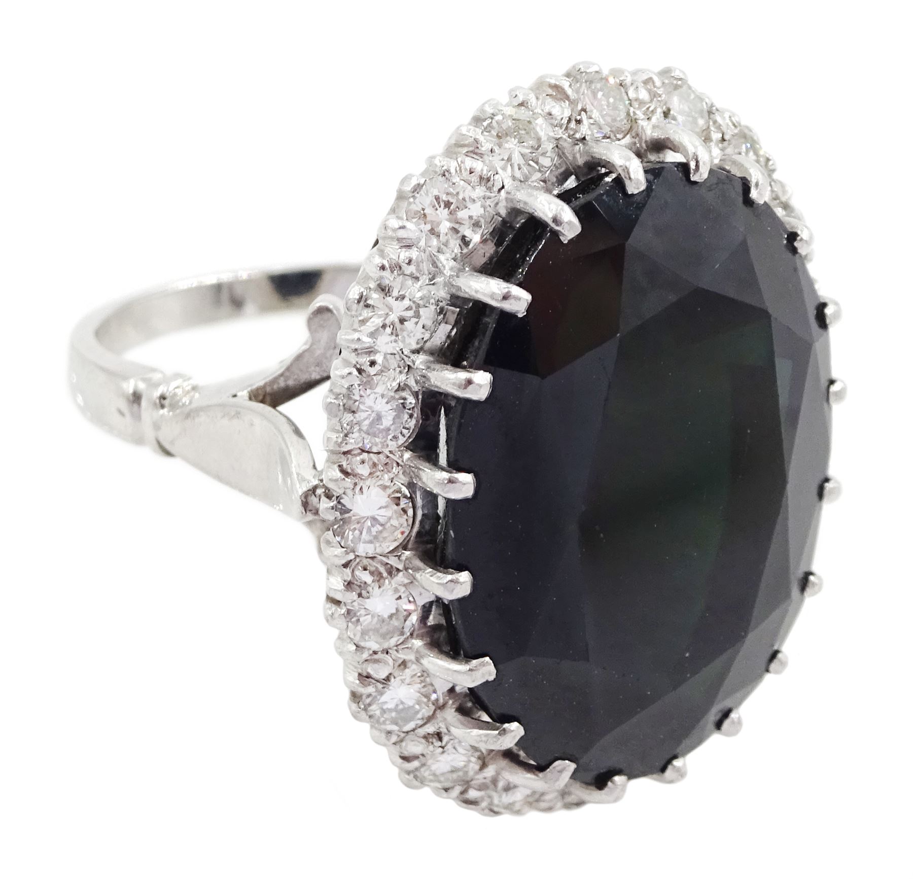 18ct white gold large oval sapphire and round brilliant cut diamond cluster ring, sapphire approx 27.35 carat, total diamond weight approx 1.00 carat