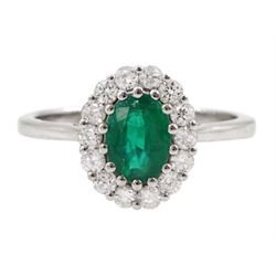 18ct white gold oval emerald and round brilliant cut diamond cluster ring, stamped, emerald approx 0.70 carat, total diamond weight approx 0.40 carat