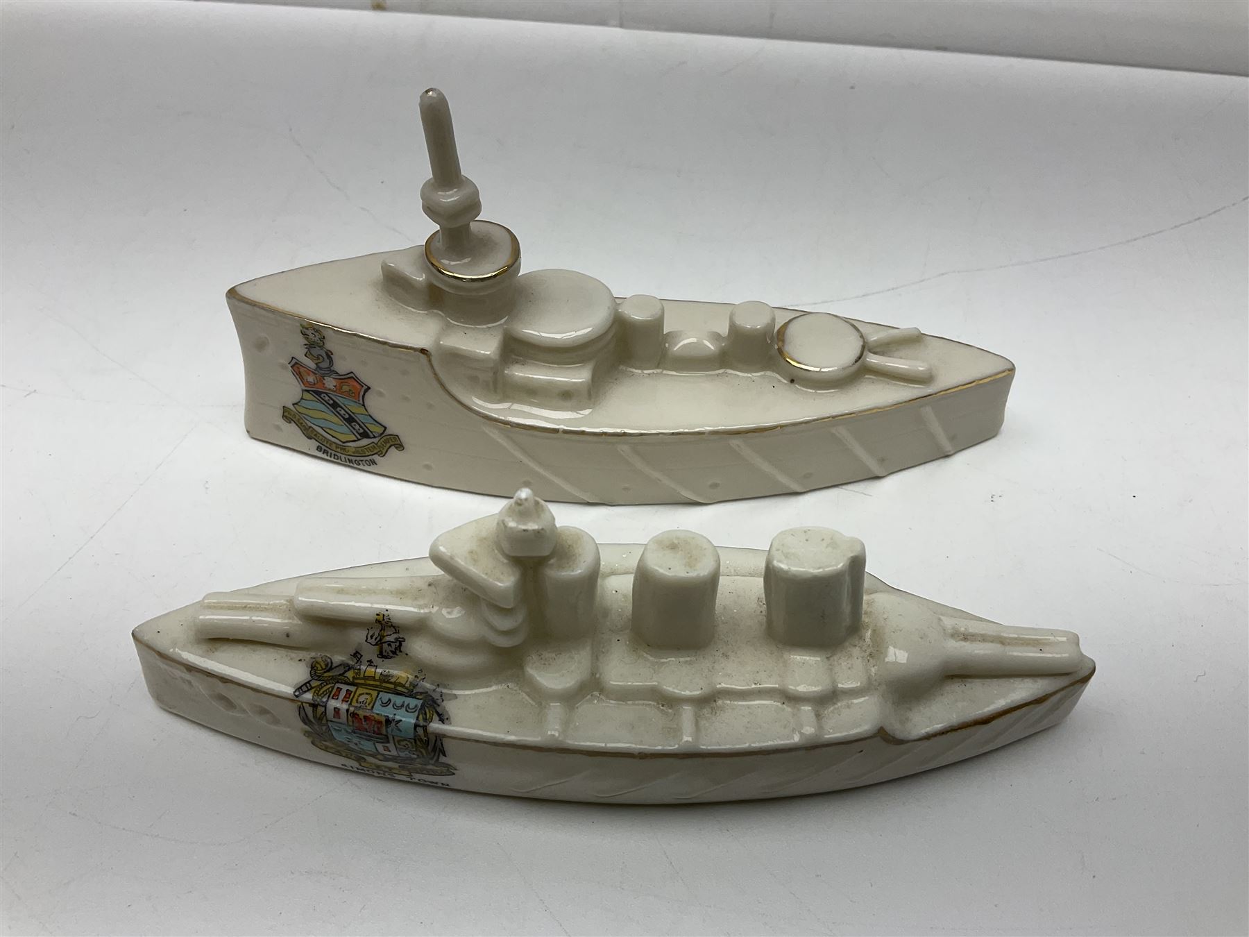 Ten WW1 crested china military models comprising submarine, four ships including Lusitania, four Zeppelins/balloons and an aircraft; various makers including Arcadian China, Swan China, Carlton China, Waterfall, Grafton China etc; various crests including Saint Neots, Great Yarmouth, Tewksbury, Swanage, Simons Town, Hull etc (10)