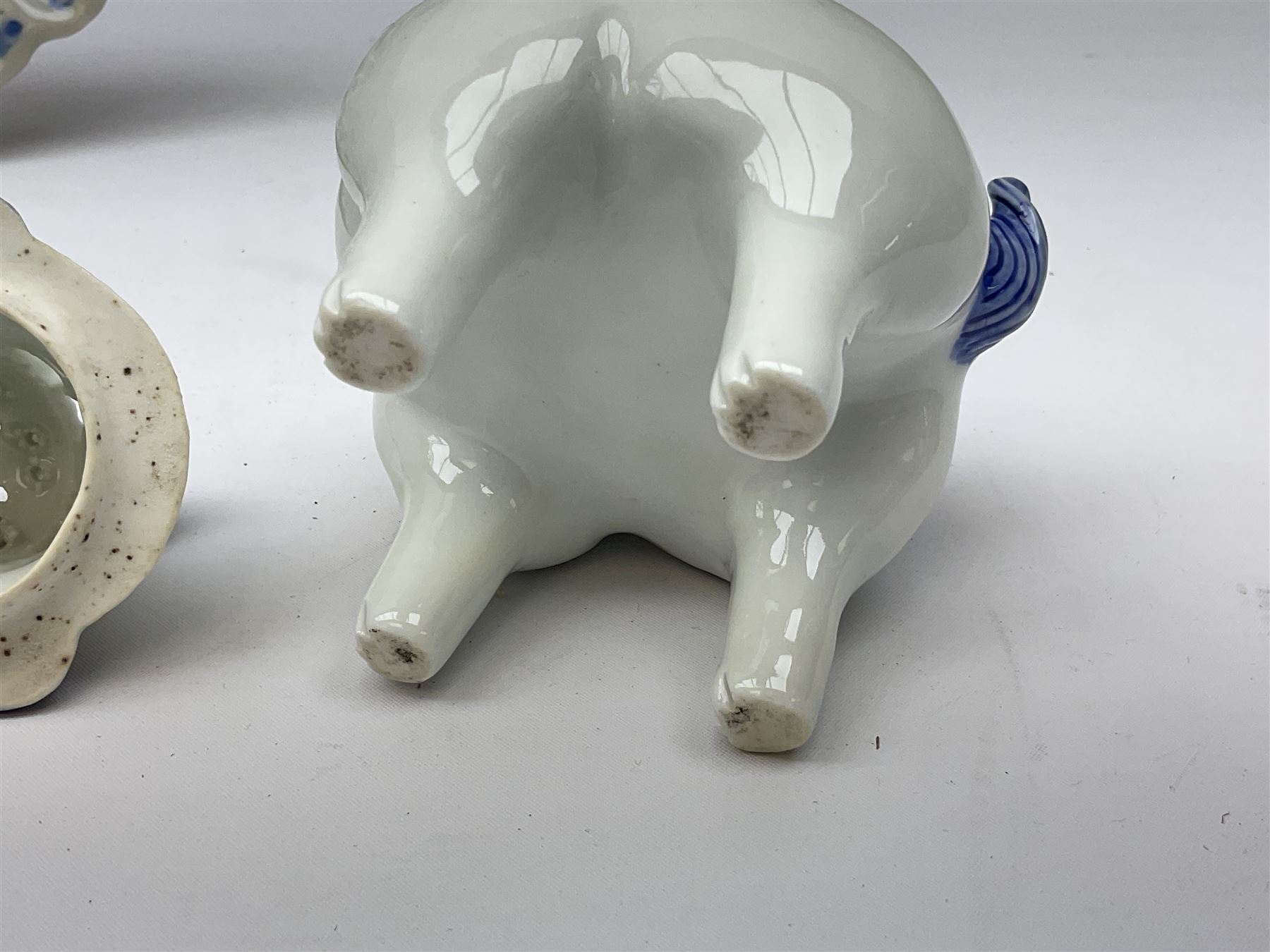 Japanese Hirado blue and white porcelain censer in the form of a Lion Dog, together with a Hirado porcelain shell shaped dish, centrally decorated with an exotic bird flanked by two roundels on floral scroll ground, censer H13cm