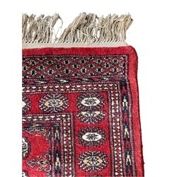 Tekke Bokhara red ground rug, decorated with two rows on Gul motifs, geometric design borders decorated with stylised floral motifs 