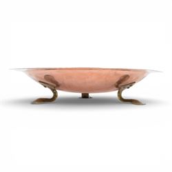 Arts and Crafts Birmingham Guild of Handicraft copper bowl, of circular form, the broad rim stamped with circles and fruiting sprigs, raised upon three cast brass feet, with impressed mark beneath The Birmingham Guild Ltd England, D30cm