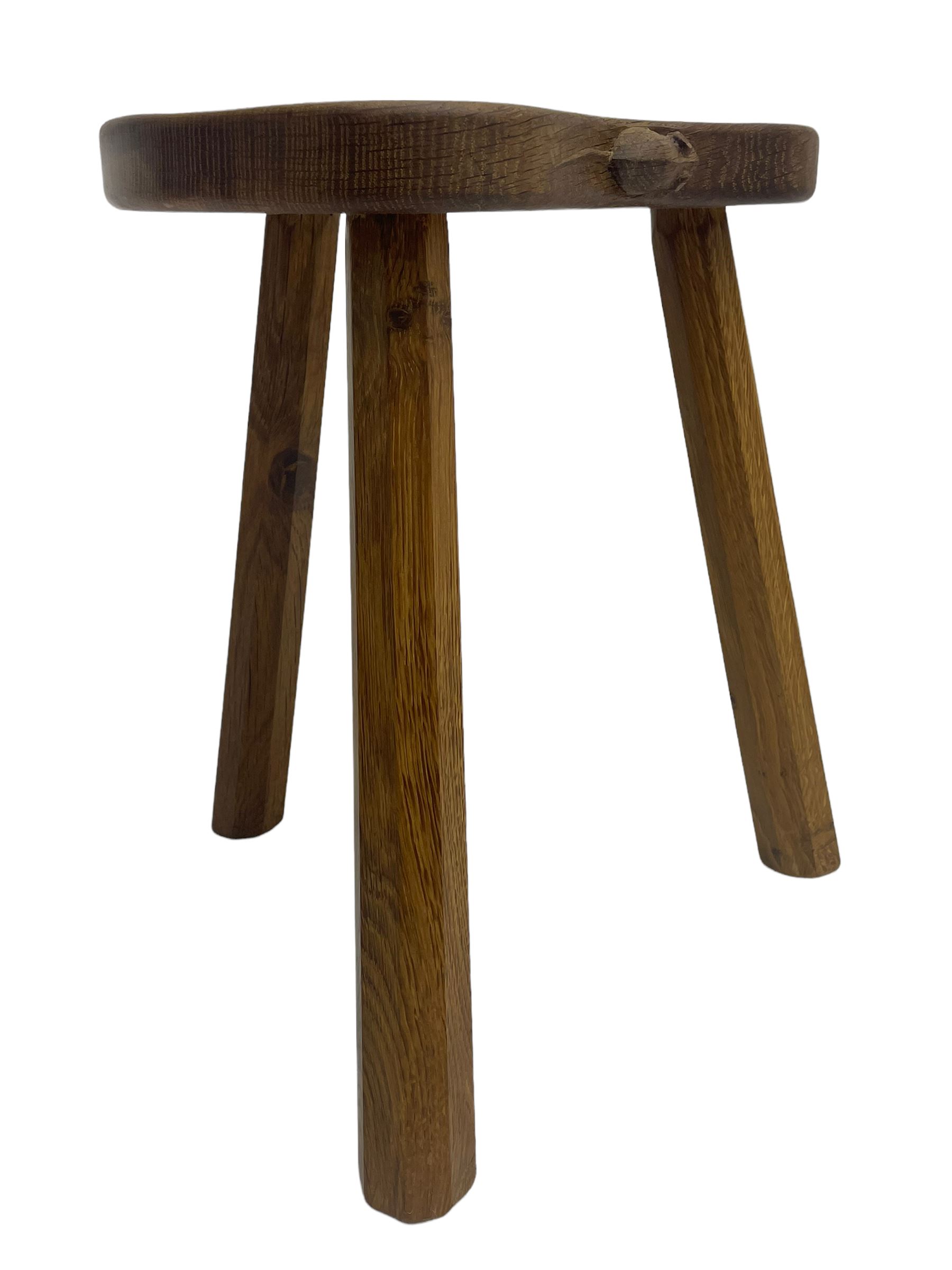'Mouseman' oak three-legged stool, kidney shaped dished seat carved with mouse signature to edge, by Robert Thomas of Kilburn