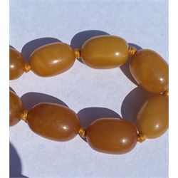 Single strand graduating oval butterscotch amber bead necklace, with three additional loose amber beads