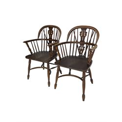 Pair late 20th century oak Windsor elbow chairs, double hoop and stick back with pierced and fretwork work splat, dished seat on turned supports joined by crinoline stretcher