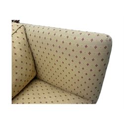 20th century Knole design two seat sofa, high back and double drop-arm joined by mahogany finials and ties, upholstered in camel ground fabric with red lozenge design, on turned supports with brass castors