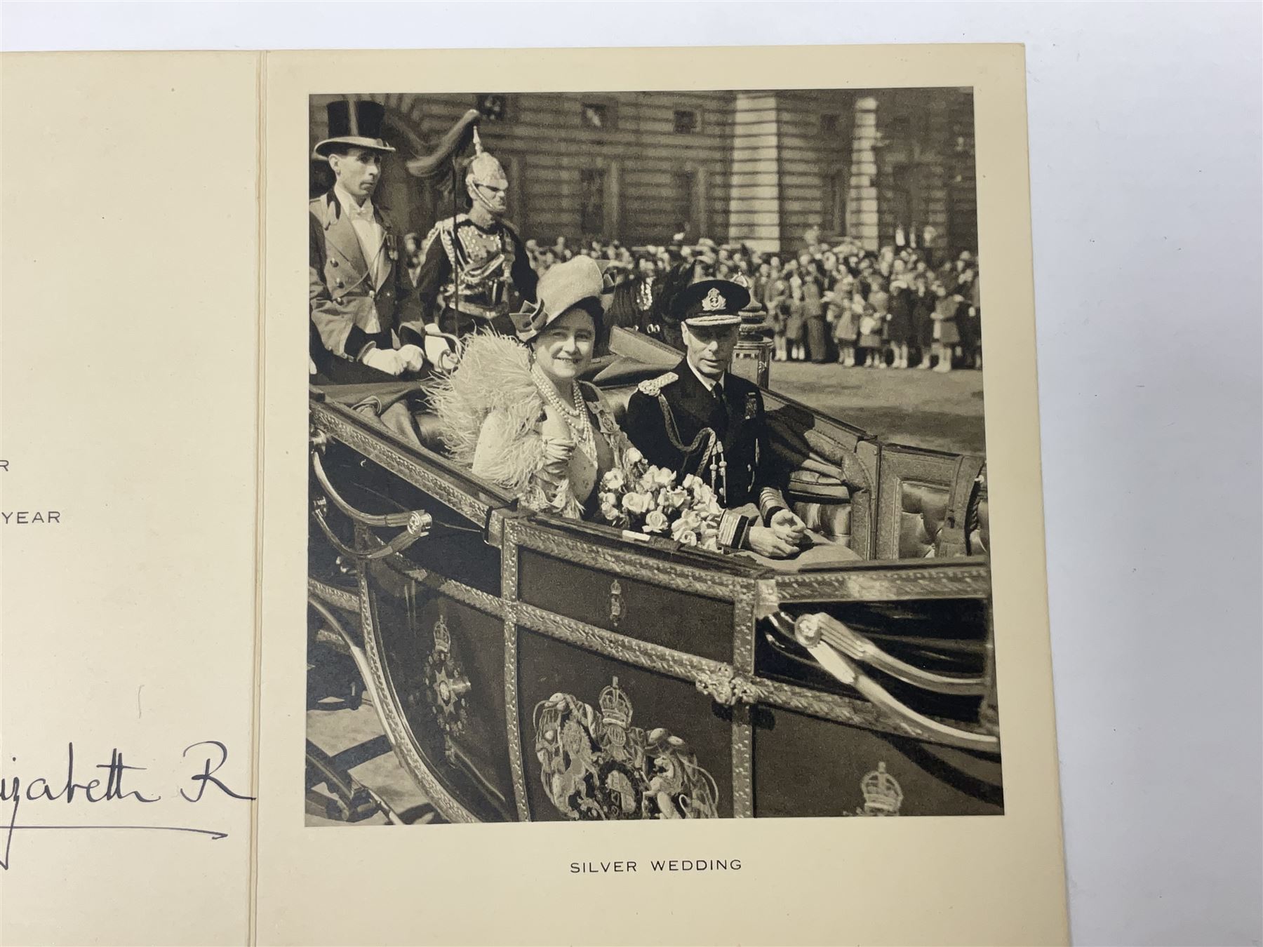 King George VI and Queen Elizabeth - signed 1949 Christmas card with gilt embossed crown to cover, black and white photograph to the interior, of The King and Queen riding in an open carriage to their Silver Wedding Celebration, signed 'George R. Elizabeth R.'