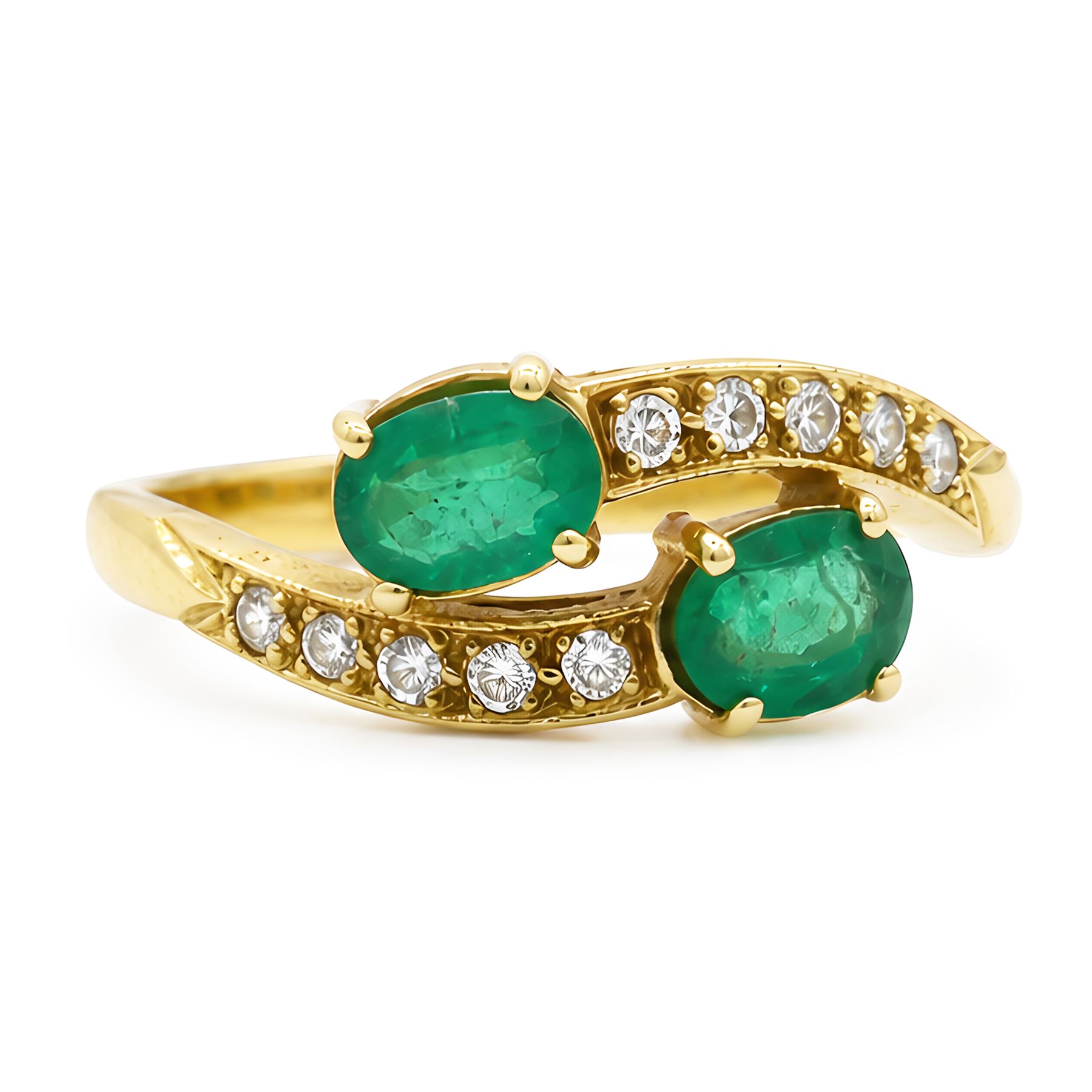 18ct gold emerald and diamond crossover ring, set with five round brilliant cut diamonds and two oval cut emerald finials, Sheffield 1989, total emerald weight approx 0.40 carat
