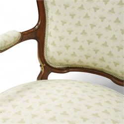 Louis XV design salon suite comprising a pair of walnut and parcel-gilt fauteuil armchairs together with a side chair, the cresting rail surmounted with a carved giltwood floral shell motif with extending foliage, the cartouche shaped backs and sprung seats upholstered in pale blue patterned fabric, over a shaped apron with scallop decoration and foliage carved knees, raised on cabriole supports