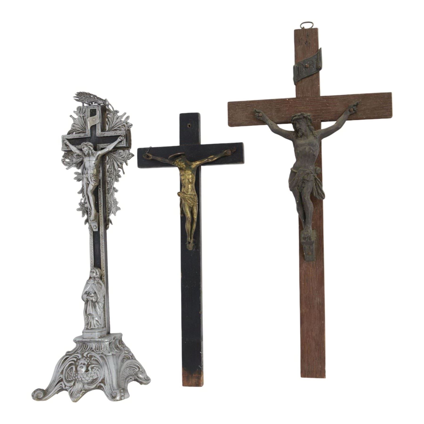 Eight crucifixes with Corpus Christi, various ages and materials, including wood and medal examples, largest H120cm 