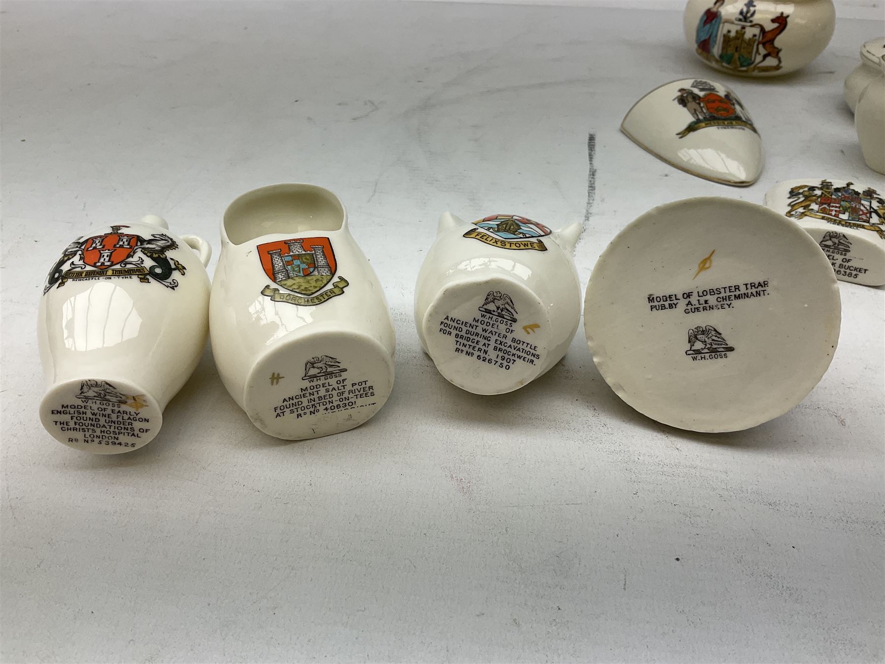W H Goss crested china to include Guernsey lobster trap, Newcastle-on-Tyne wine flagon, Felixstowe water bottle, Dorchester salt pot etc