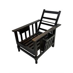 Late Victorian oak steamer chair, adjustable slatted backrest with grooved crest rail, wide armrests extending to a sliding adjustable footrest, open frame sides with vertical slats, side magazine rack and collapsible table, raised on turned front supports