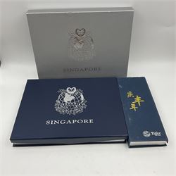Singapore Venhonia commemorative medallion collection and a Tiger Beer commemorative three-medallion collection, both cased with certificates