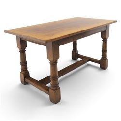 Titchmarsh & Goodwin style solid oak refectory table, rectangular top raised on block and turned supports united by a full length undertier