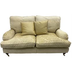 Multi-York - Howard shape two-seat sofa, upholstered in scrolling floral pattern loose covers, rolled arms, on turned front feet with brass cups and castors