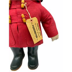 Gabrielle Designs Paddington Bear in a red felt jacket and black felt hat, c1972. Dunlop bottle green wellingtons and Darkest Peru label. H54cm
