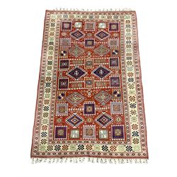 Turkish Kazak red ground rug, the field decorated with a combination of lozenge and square stylised motifs, repeating guarded border