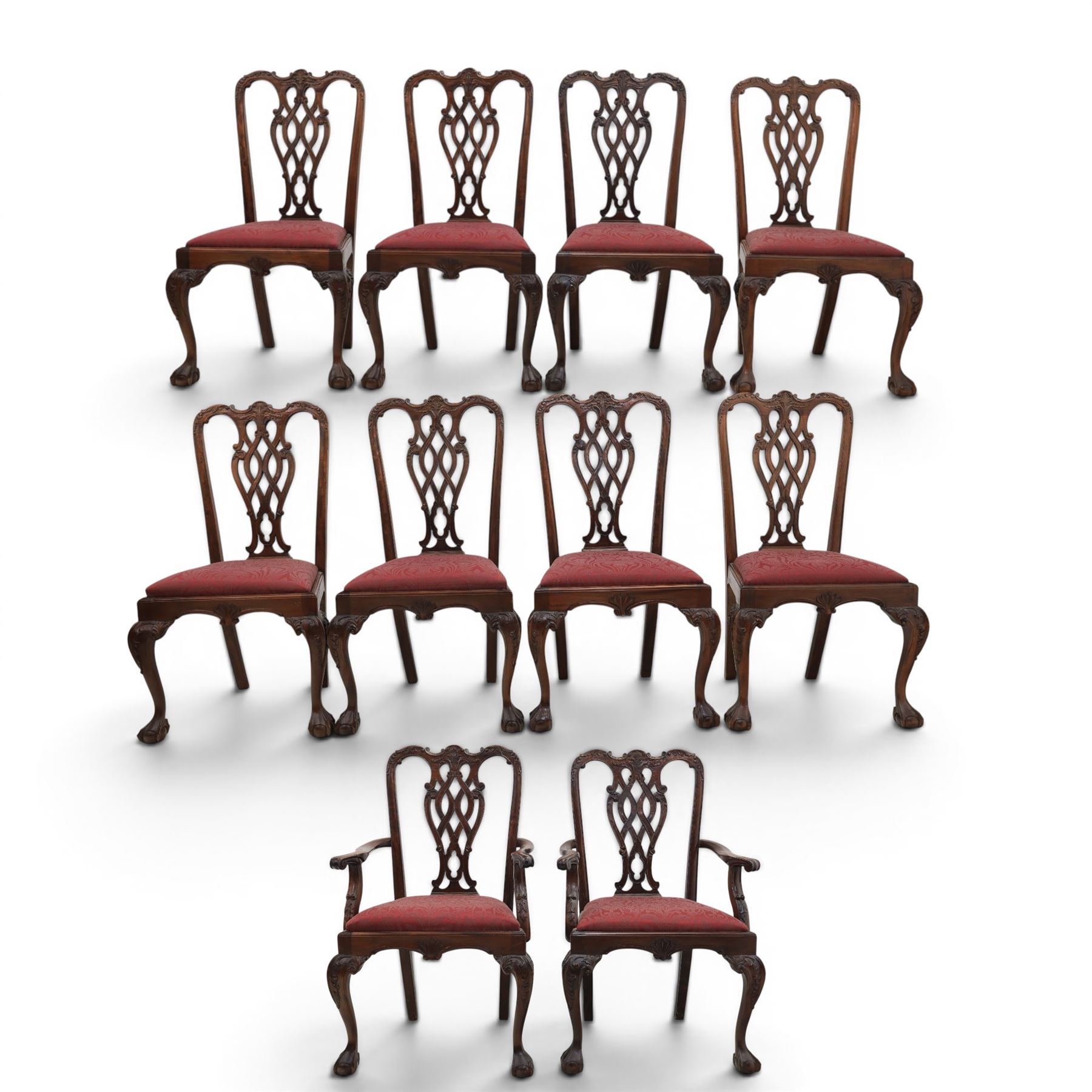 Chippendale design set of ten (8+2) mahogany dining chairs, serpentine cresting rails with carved detail over pierced ribbon-tied splats, red damask upholstered drop-in seats, on cabriole supports with acanthus carved knees and claw and ball feet