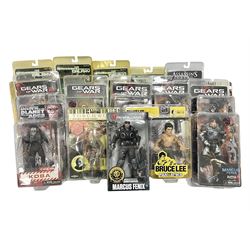 Sixteen carded action figures comprising seven 'Gears of War'; four 'Hitchhikers Guide to the Galaxy'; two 'Torchwood'; 'Planet of the Apes'; 'Bruce Lee'; and 'Assassin's Creed'; all in unopened packs (16)