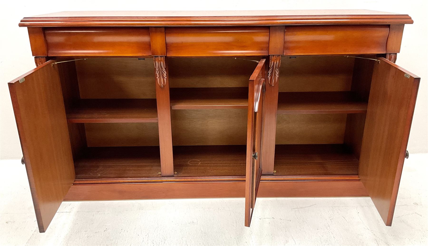 Waring & Gillow - cherry wood sideboard, three drawers above three cupboards, skirted base