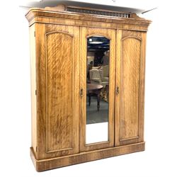 Victorian satinwood triple wardrobe, enclosed by two panelled and one mirror glazed door, the central compartment fitted with linen slides and drawers