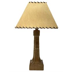 'Mouseman' tooled oak table lamp, the octagonal tapered stem carved with mouse signature, with shade, by Robert Thompson of Kilburn