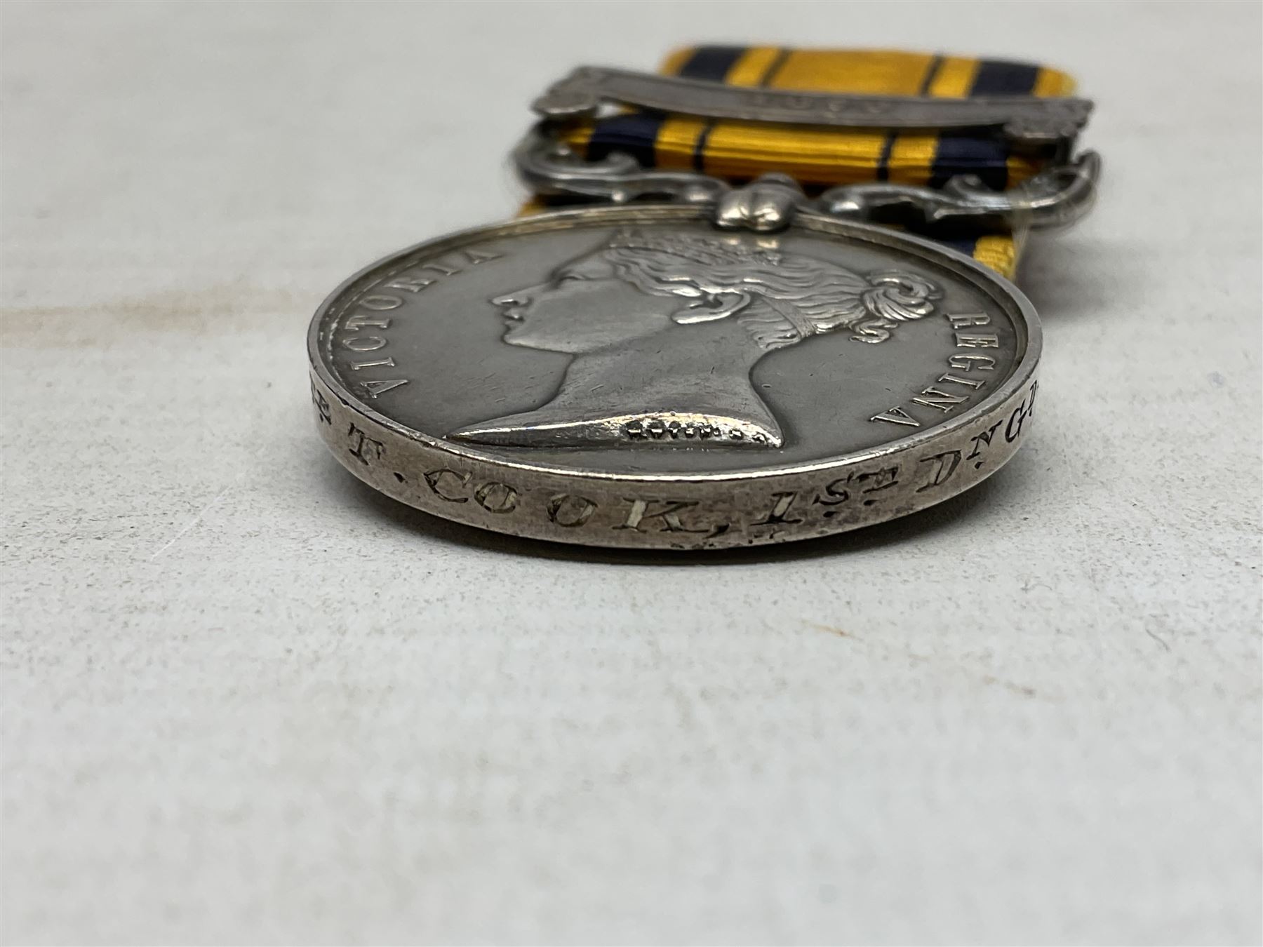 Victoria South Africa (Zulu) Medal with clasp for 1879, awarded to 2112 Pte. T. Cook 1st Dgn. Gds. with card stiffened ribbon