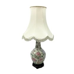 Oriental table lamp of bulbous form, decorated with pink blossoming branches and birds upon plain ground, upon stepped circular wood base with tasselled fabric shade, incl shade approx H83cm