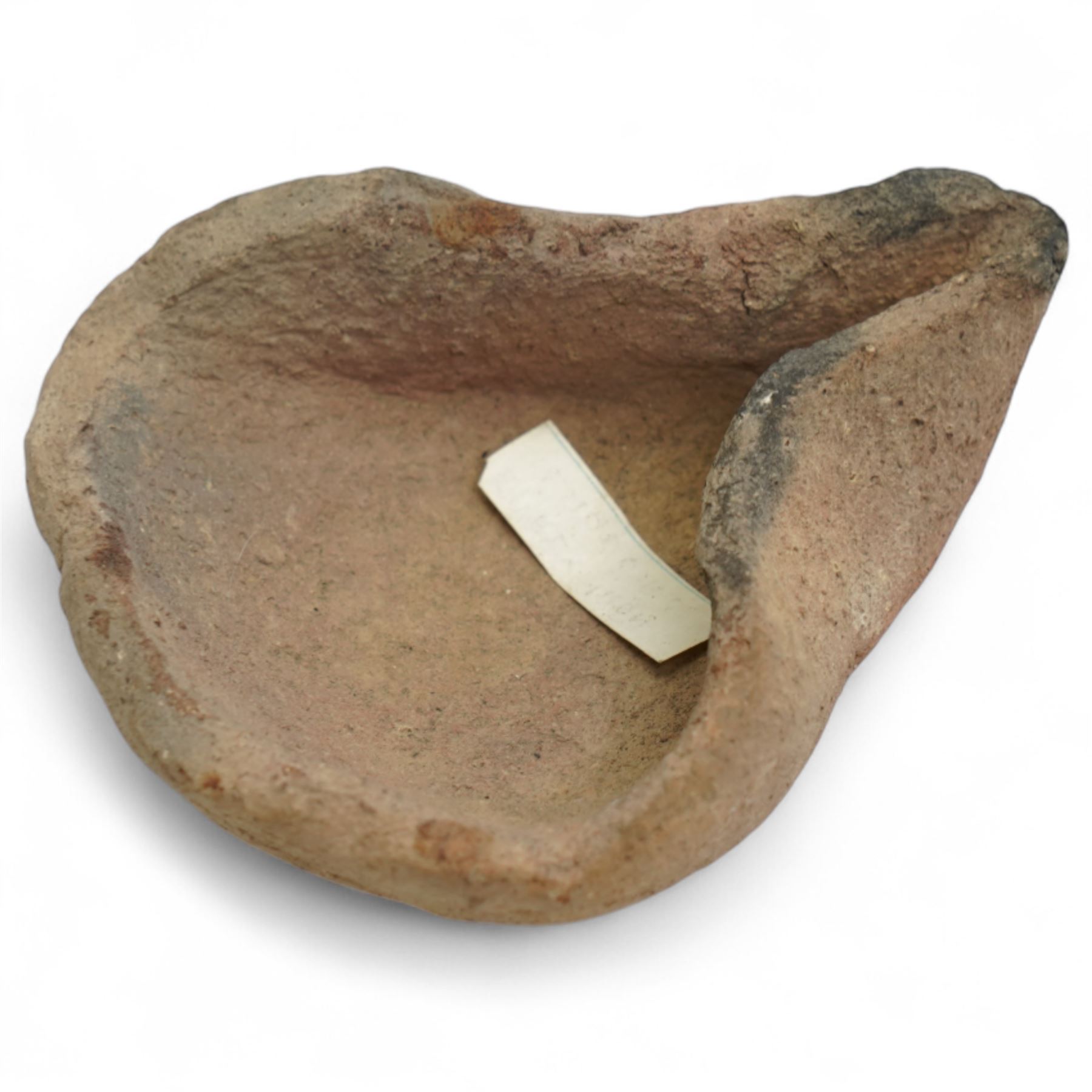 A group of five ancient terracotta oil lamps - Near East and Eastern Mediterranean (c.3rd millennium BC-9th century AD) comprising: Levantine open bowl-type lamp (c.3rd-2nd millennium BC) hand-formed with pinched spout and rounded profile; Near Eastern pinched-spout lamp (c.1200 BC) of coarse red clay with wide central fill hole; Roman oil lamp (c.1st-2nd century AD) with flared spout and a rosette-stamped base; Roman circular oil lamp (c.2nd-3rd century AD) with deeply moulded floral decoration in high relief around the fill hole; and a larger Early Islamic (Arab) lamp (c.7th-9th century AD) decorated with incised geometric motifs to the upper surface
Provenance: By the vendor’s repute, acquired/collected in the Middle East (Dead Sea area/Syria) in the 1960s