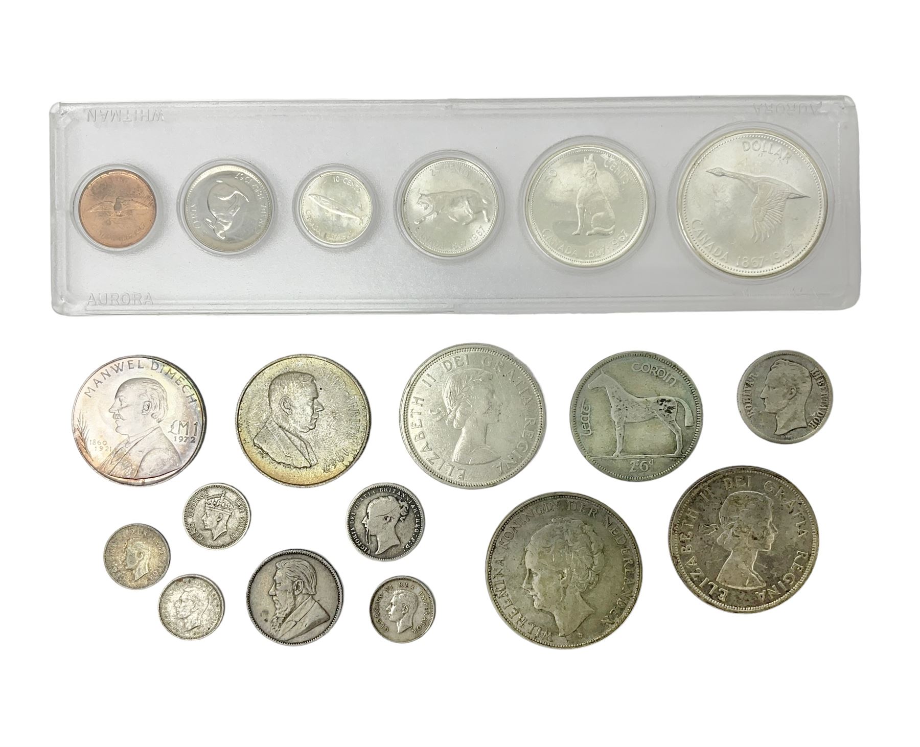 South Africa 1897 one shilling, 1967 one rand, Ireland 1928 two shillings and sixpence, Netherlands 1930 two and a half gulden, two Queen Elizabeth II Canada one dollar coins dated 1958 and 1964, 1967 six coin set in plastic holder etc