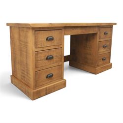 Indigo Furniture - rustic oak twin pedestal desk, rectangular plank top, with central frieze drawer, the fixed pedestals with three drawers and metal cup handles, raised on a plinth base