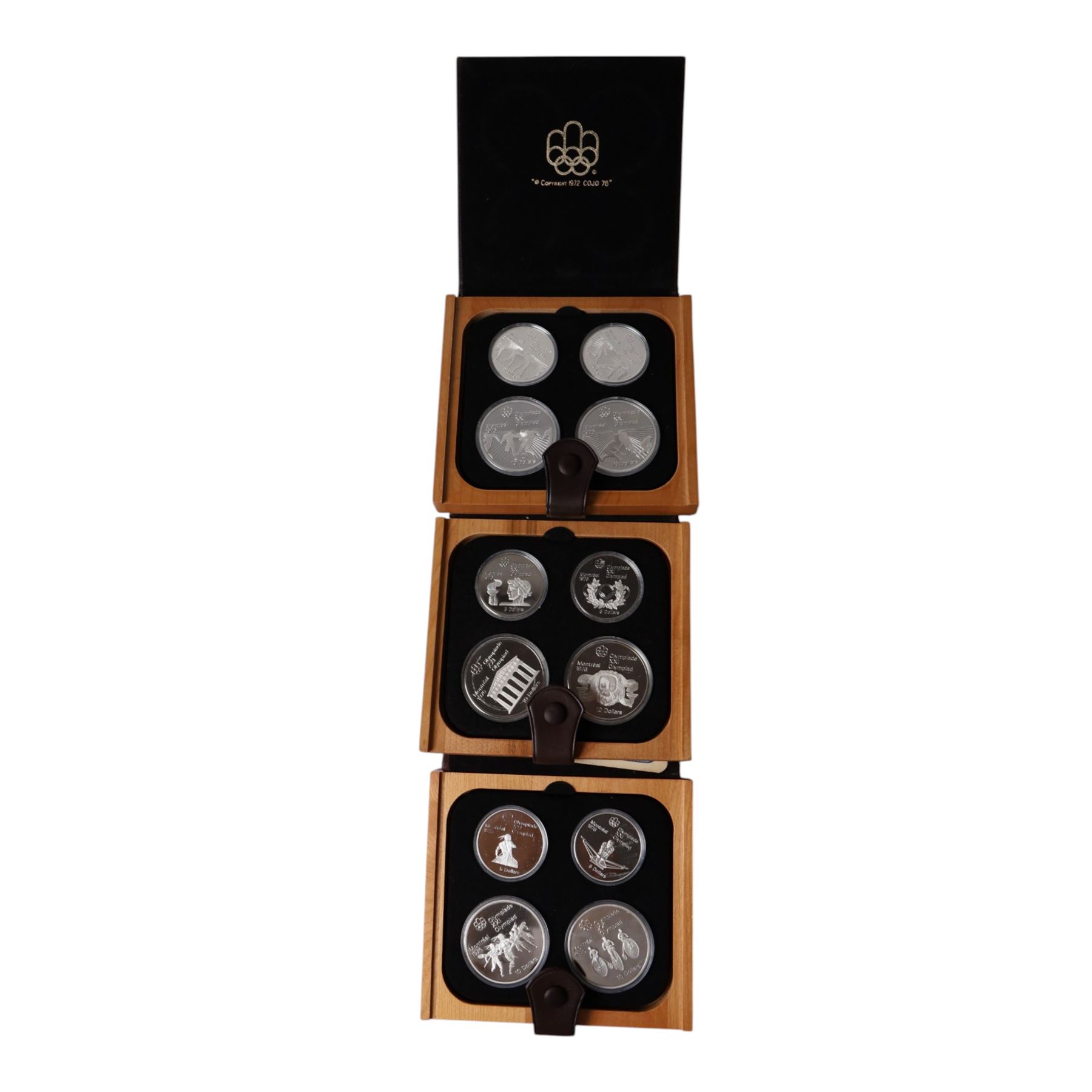 Seven Royal Canadian Mint 1976 'Montreal Olympics' silver proof four coin sets, each containing two five dollar and two ten dollar coins, each cased and boxed with certificates