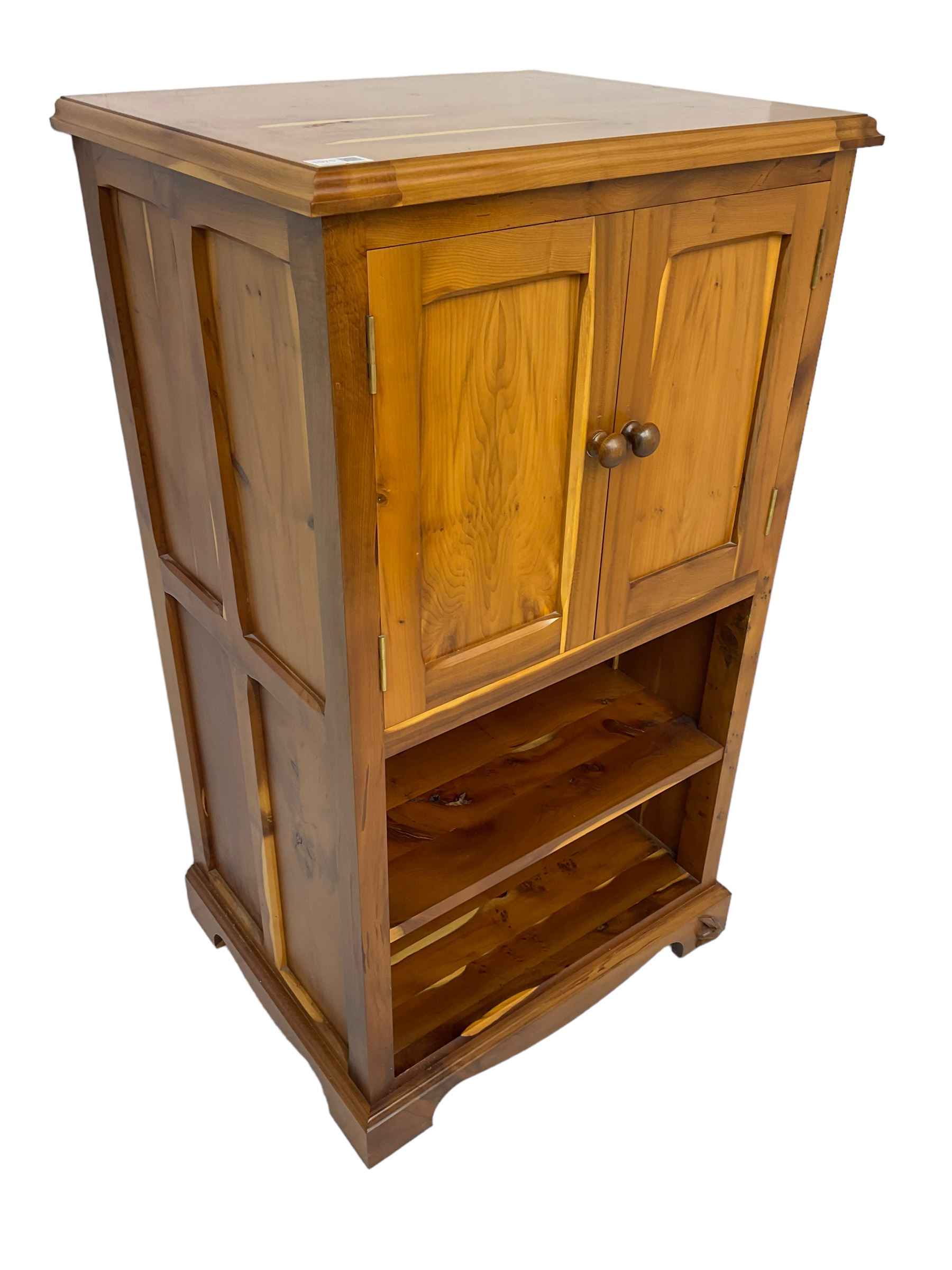 Unicornman - yew wood cabinet, moulded hinged lid over two panelled doors and shelves (W56cm, H99cm, D45cm); and four Unicorn man CD racks two in yew wood and two in oak (W20cm, H36cm, D20cm); all carved with unicorn signature and by Geoff Gell, Coxwold
