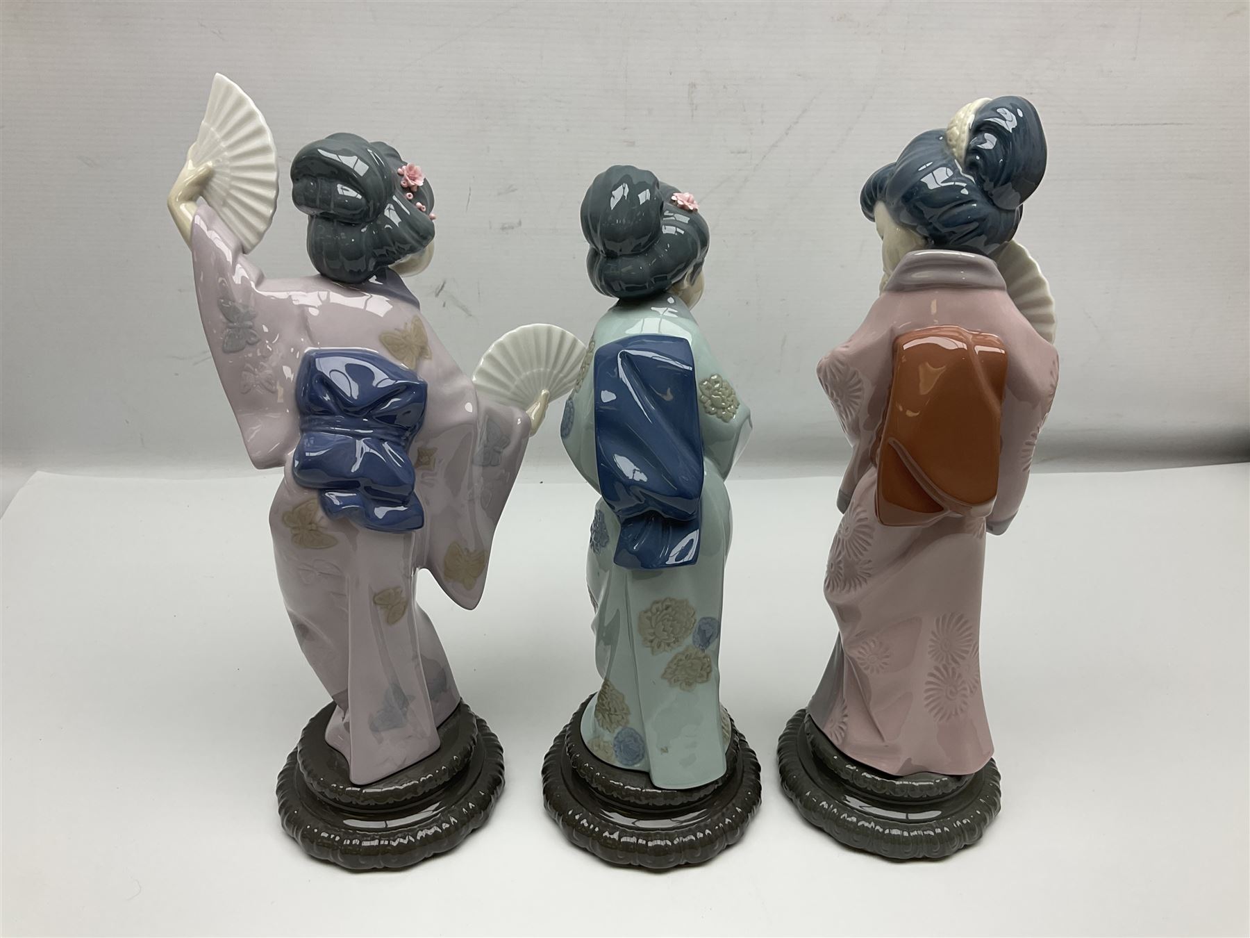 Three Lladro Japanese figures, comprising Sayonara no. 4989, Chrysanthemum no. 4990 and Madame Butterfly no. 4991, largest H30cm