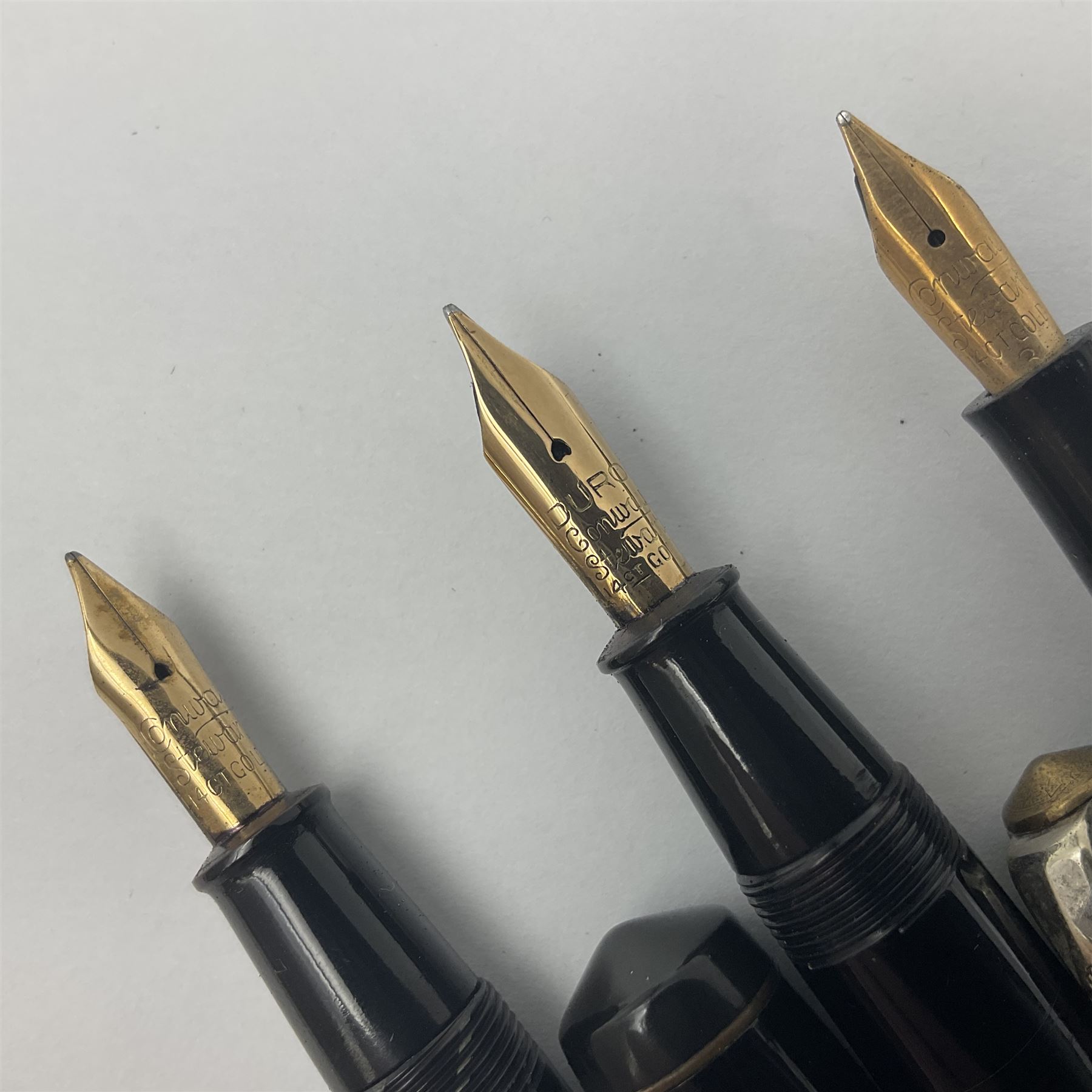 Three Conway Stewart fountain pens, comprising Cracked Ice 28 pen, the black and pearl white barrel engraved Conway Stewart 28 and double banded cap, with gold nib stamped 14ct, together with a Conway Stewart 75 lever fill pen, the green marble barrel and cap with single band and gold nib stamped 14ct and Conway Stewart 55 lever fill fountain pen with black barrel and cap with single broad band and two narrow bands with gold nib stamped Duro 14ct, largest L13cm
