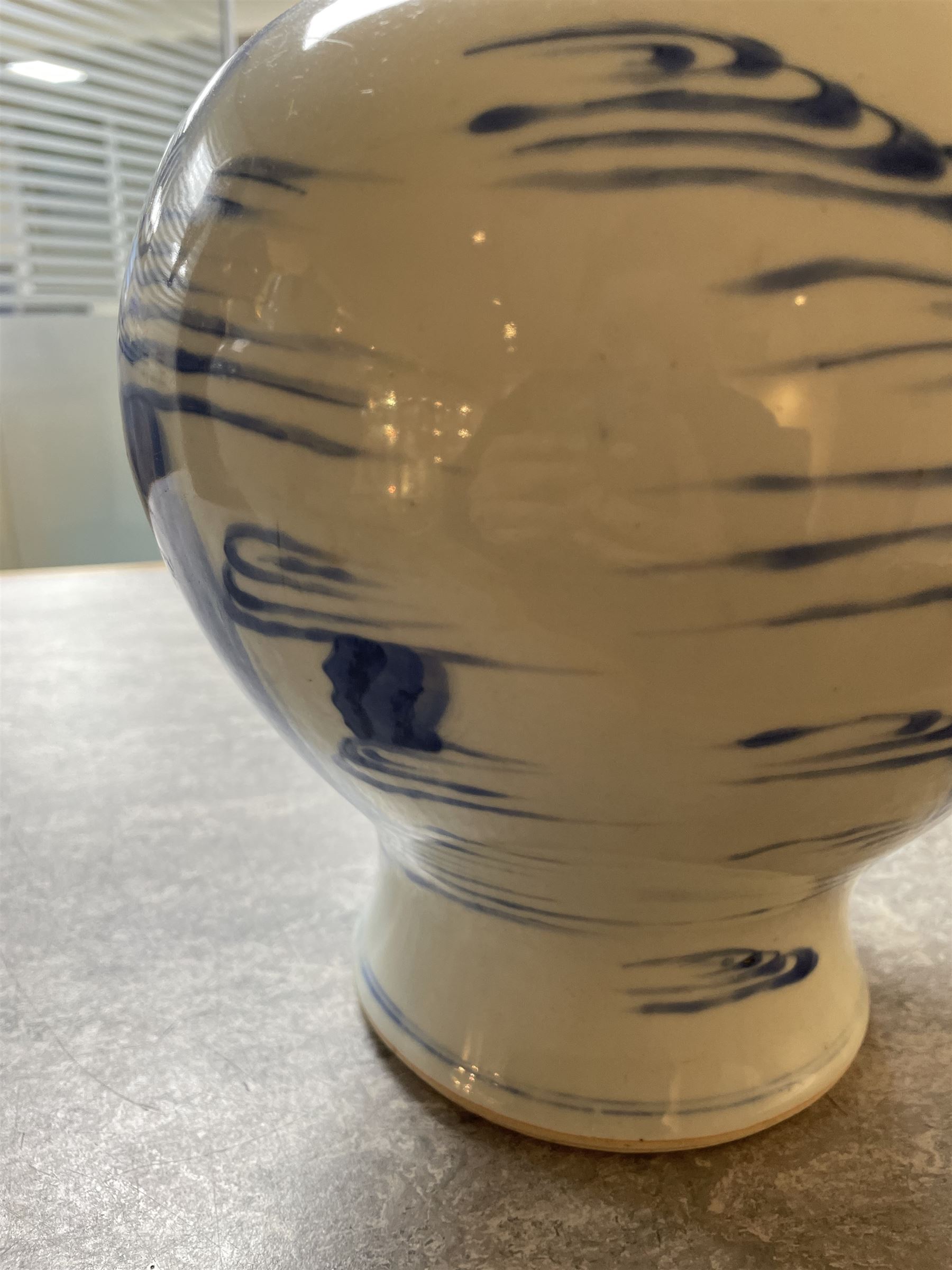 Pair of Chinese Kangxi blue and white porcelain vases, each of baluster form, painted with an outdoor scene containing figures seated upon the ground reading scrolls and holding fans, willow and bamboo tress, rock work and water, H27cm