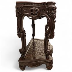 Chinese stained hardwood side table, late Qing dynasty style, with shaped top above a pierced and carved frieze of foliage and fruiting vines, cabriole legs terminating in scroll feet, united by a carved shaped undertier