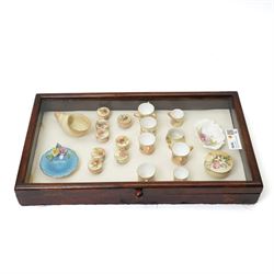 Large collection of miniature Royal Worcester hand-painted blush ivory wares, including shell shaped dish, and various covered trinket dishes, in glazed display case