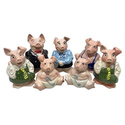 Seven Wade NatWest money boxes, comprising father, mother, boy, two girls and two babies