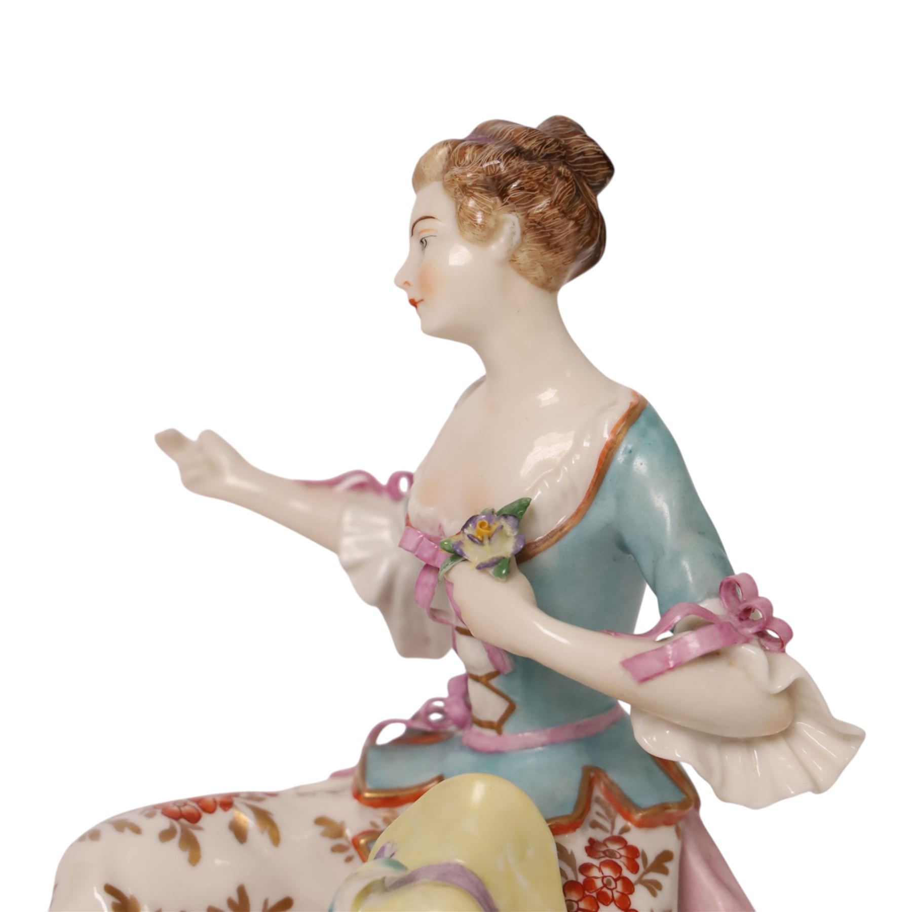 Pair of 19th century Samson figures, the gentleman wearing a wide brimmed hat with a dog, the lady with a sheep by her side, both figures seated upon a floral encrusted pillars with gilt scrolling base, H22cm