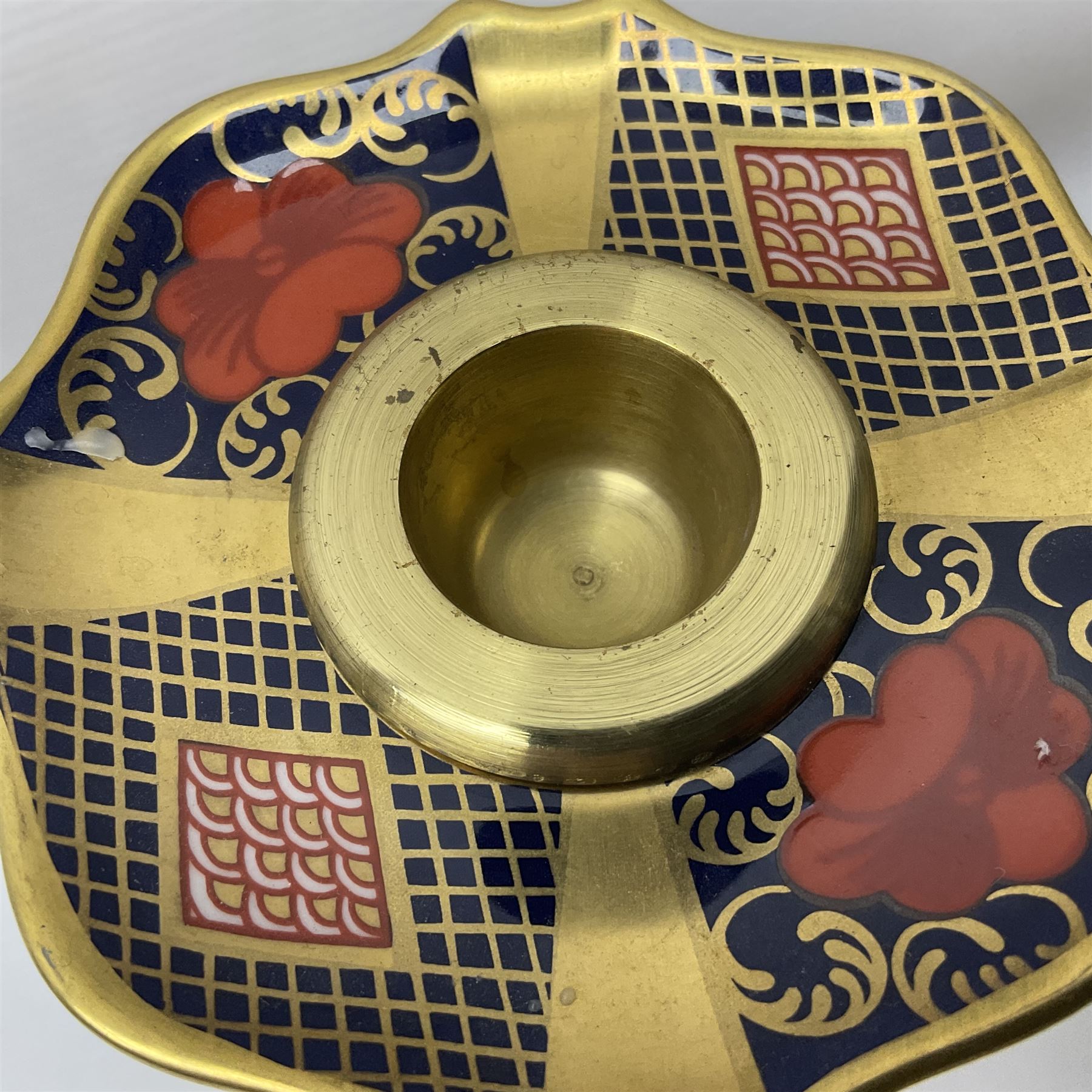 Pair of modern Royal Crown Derby Old Imari 1128 pattern candlesticks, each with shaped drip tray affixed to squat socket, upon spreading stem and canted square base with gilt dolphin edges, with printed marks beneath including Roman numeral year cypher for 2003, H26.5cm, with original boxes