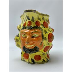 An early 19th century Staffordshire canary yellow Satyr mask jug, decorated with stylised leaves, red enamel circles and silver coloured lustre, H11.5cm. 
