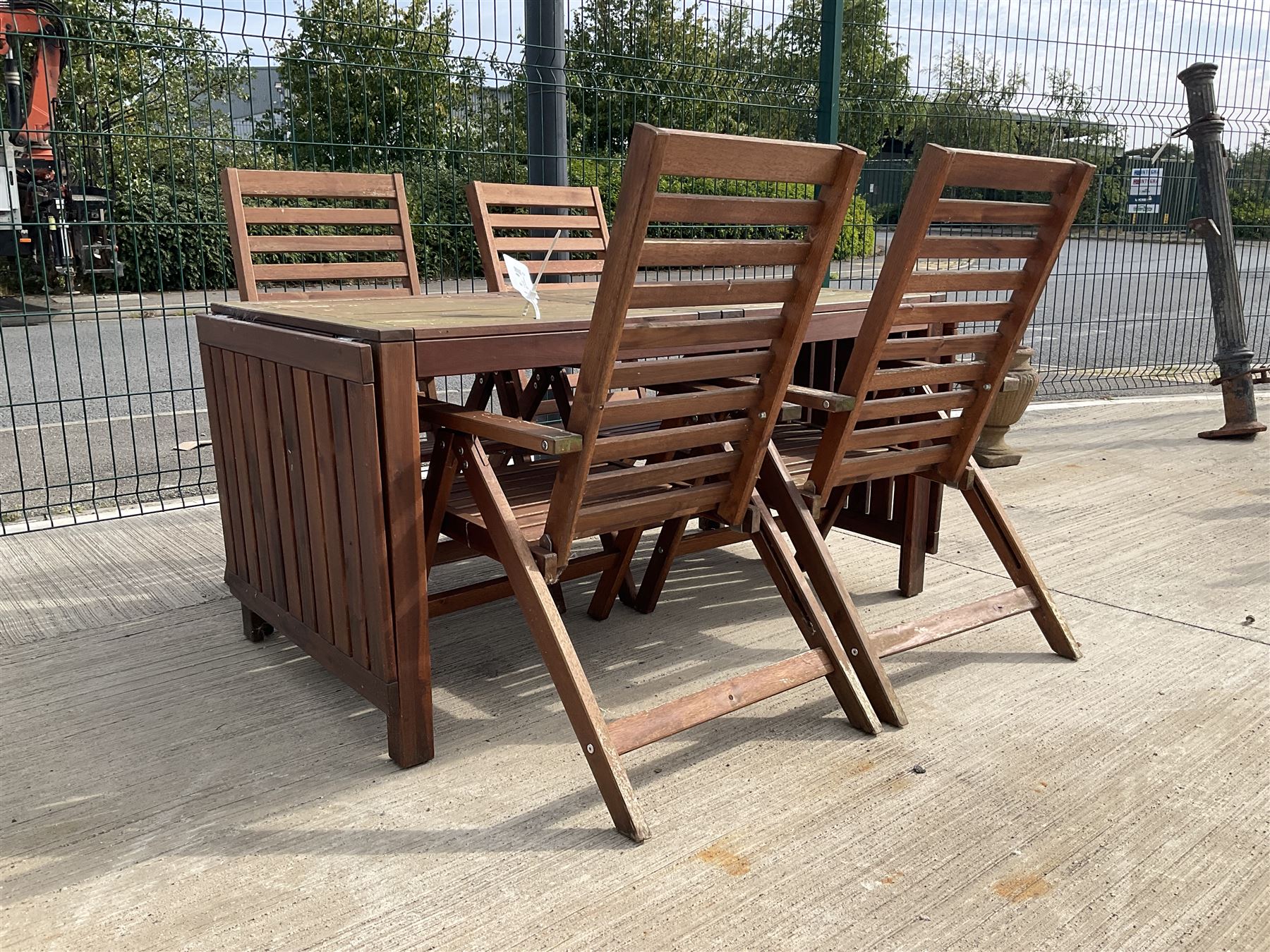Rectangular teak drop leaf garden table, and four slatted armchairs