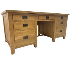 Light oak twin pedestal desk, fitted with seven drawers