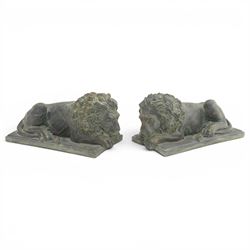 Pair of bronze effect lion figures, recumbent form with carved-style manes and outstretche...