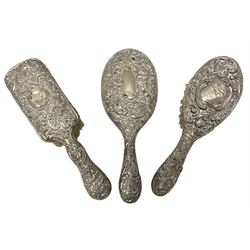 Three piece silver mounted dressing table set, comprising hand held mirror, hair brush, and clothes brush, all hallmarked 