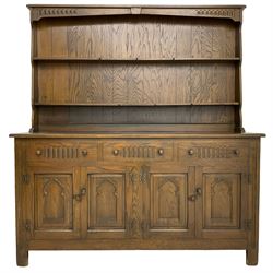 Medium oak dresser, raised two-tier plate rack over three drawers and two double cupboards, enclosed by panelled doors