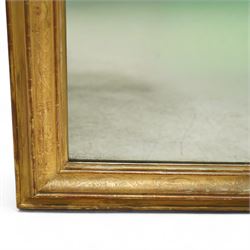 Louis XVI style gilt overmantel mirror, arched rectangular form with moulded frame, surmounted by a pediment carved with ribbon-tied grapevine and leaf decoration, enclosing a plain mirror plate, circa 1900